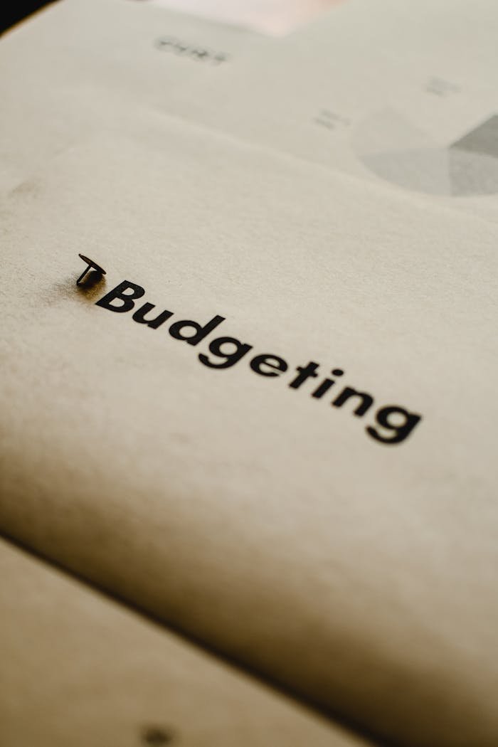 Close-up of budgeting concept on paper with focus on typography and abstract elements.